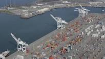 This file photo shows the former Oakland Army base pier at left and the Port of Oakland at lower ri...