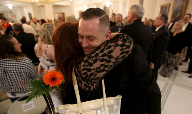 FILE PHOTO -- Christine Carlisle hugs her son Adam Carlisle after he graduated during a combined gr...