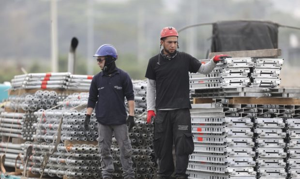 Workers build the stage for the upcoming “Venezuela Aid Live” concert at the Tienditas Internat...