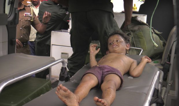 A Sri Lankan girl is taken to a hospital after she was found at the site of an explosion and a gunb...