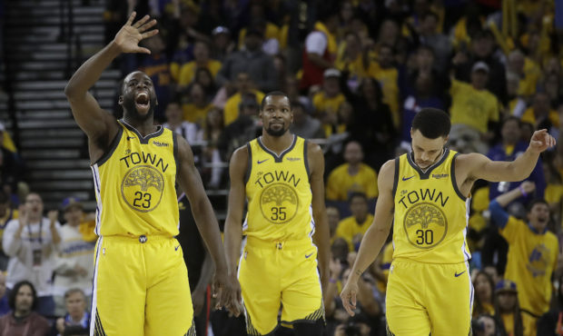 Golden State Warriors forward Draymond Green (23), forward Kevin Durant (35) and guard Stephen Curr...