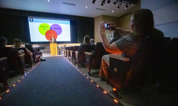 Jordan School Board President Bryce Dunford announces potential teacher raises during a presentatio...