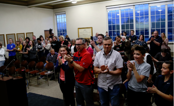 Spenser Heaps, Deseret News
People rise in a standing ovation after a resolution adopting an offici...