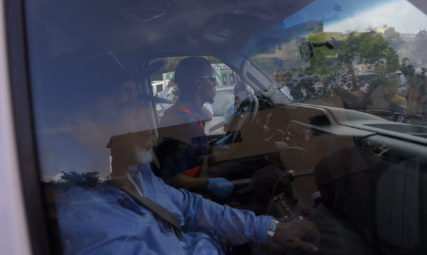 Leo Ortiz, left, the father of former Boston Red Sox slugger David Ortiz, sits in the ambulance tha...