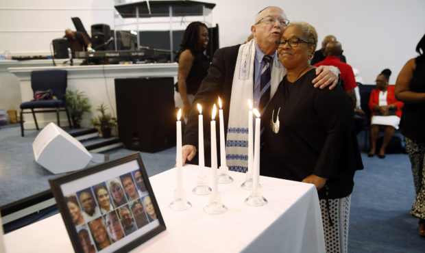 Rabbi Israel Zoberman, left, embraces churchgoer Pamela Johnson after a vigil at Piney Grove Baptis...