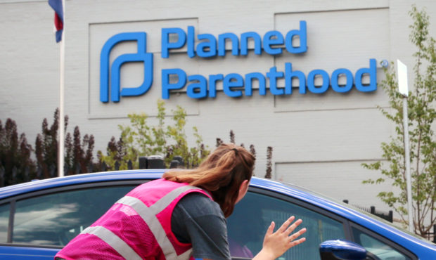 FILE - In this June 28, 2019 file photo, Ashlyn Myers of the Coalition for Life St. Louis, waves to...