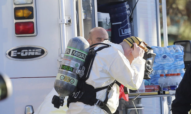 In this Nov. 22, 2016 photo, police and agents with the Drug Enforcement Administration put on prot...