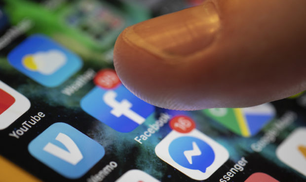 In this Sunday, Aug. 11, 2019, photo an iPhone displays the apps for Facebook and Messenger in New ...