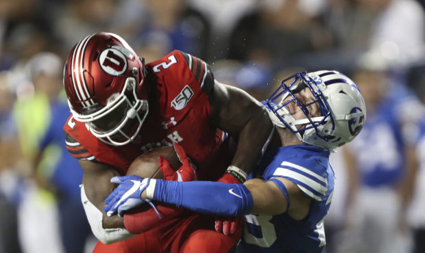 BYU defensive back Sawyer Powell (28) tries to take down Utah running back Zack Moss (2) in the fir...