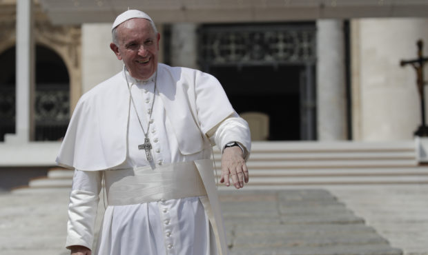 Pope Francis salutes pilgrims and faithful as he leaves St. Peter's Square at the Vatican after his...