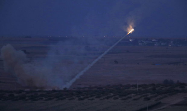 In this photo taken from the Turkish side of the border between Turkey and Syria, in Ceylanpinar, S...