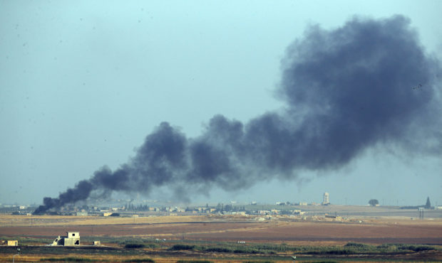 In this photo taken from the Turkish side of the border between Turkey and Syria, in Akcakale, Sanl...