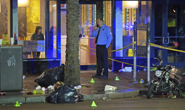 A woman looks out from inside a McDonald's fast food restaurant as New Orleans police investigate t...