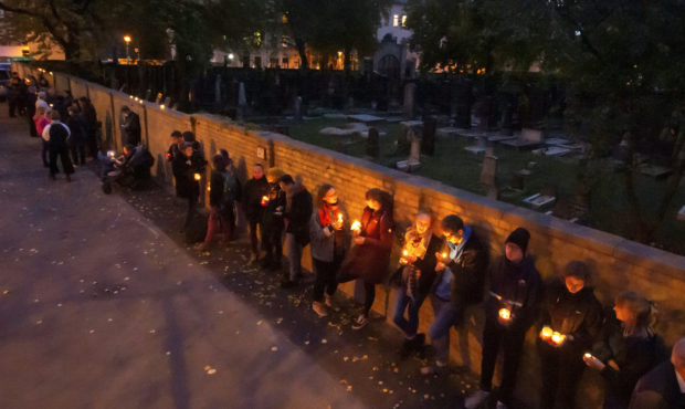 FILE - In this Oct. 11, 2019, file photo, people line up for a human chain around the Jewish synago...