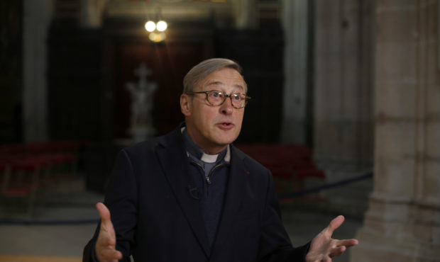 In this photo taken on Tuesday Dec. 3, 2019, Notre Dame cathedral rector Patrick Chauvet talks to t...