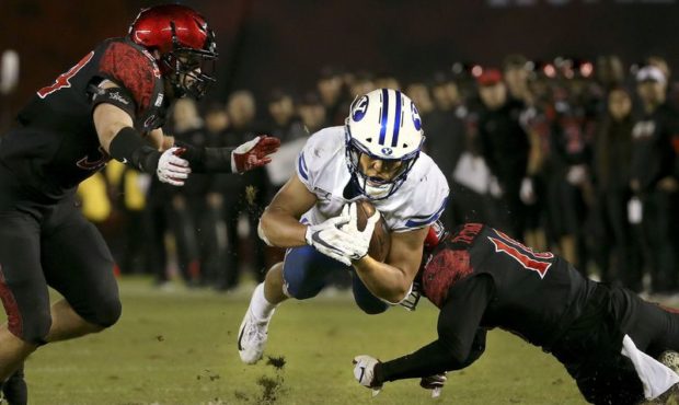 FILE-- Brigham Young Cougars running back Lopini Katoa (4) dives for yardage against San Diego Stat...