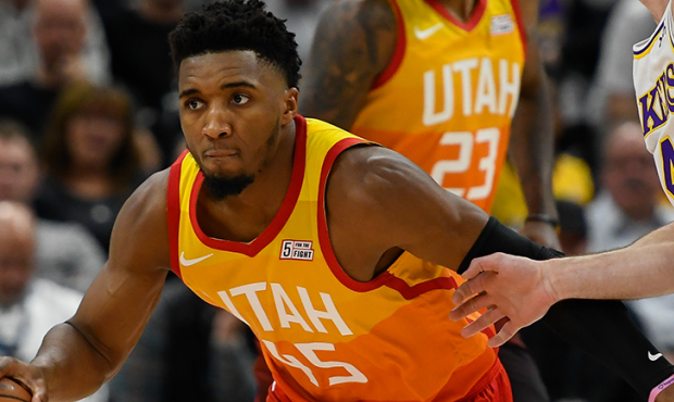 Donovan Mitchell #45 of the Utah Jazz drives past Alex Caruso #4 of the Los Angeles Lakers during a...