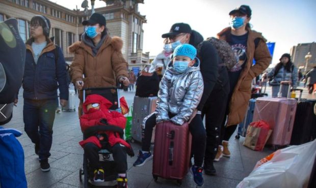 (Travelers in Beijing.  Credit: Mark Schiefelbein, AP)...