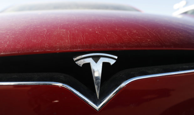 FILE - In this Feb. 2, 2020, file photo, the company logo shines on the grille of an unsold 2020 Mo...