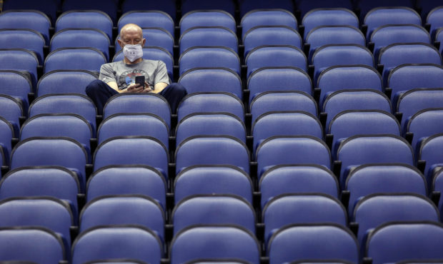 Mike Lemcke, from Richmond, Va., sits in an empty Greensboro Coliseum after the NCAA college basket...