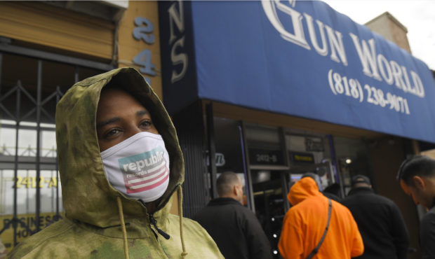 A gun store customer that gave his name only at John waits in line, Sunday, March 15, 2020, in Burb...
