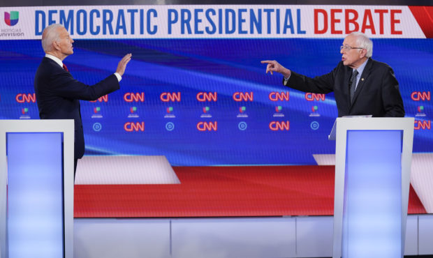 Former Vice President Joe Biden, left, and Sen. Bernie Sanders, I-Vt., right, participate in a Demo...