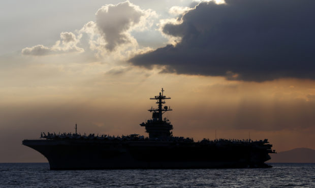 FILE - In this April 13, 2018, file photo the USS Theodore Roosevelt aircraft carrier is anchored o...