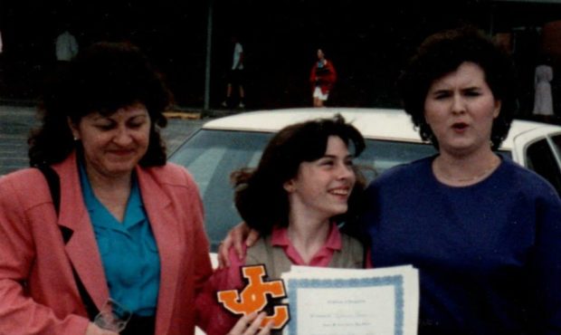 Woman in business suit with two daughters...
