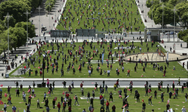 Workers Unions keep a safe distance from each other and wear face masks to help protect against the...