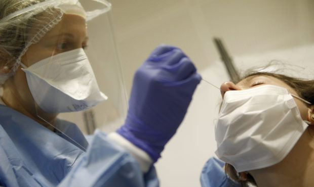 A health-care worker collects a swab sample to be tested with the Coronavirus at the European Parli...