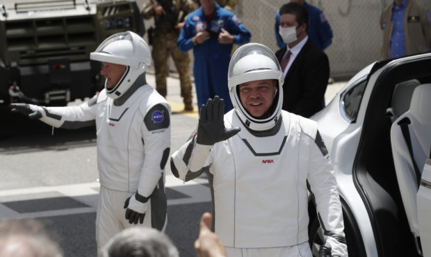 2 astronauts climb aboard SpaceX rocket for historic flight...