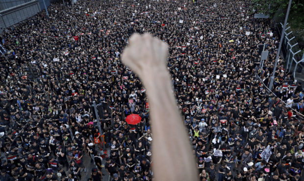 FILE - In this June 16, 2019, file photo, protesters march on the streets against an extradition bi...