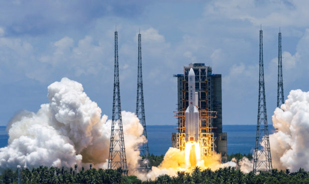 In this photo released by China's Xinhua News Agency, a Long March-5 rocket carrying the Tianwen-1 ...