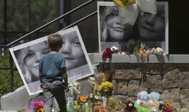FILE - In this June 11, 2020, file photo, a boy looks at a memorial for Tylee Ryan, 17, and Joshua ...