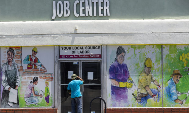 FILE - In this May 7, 2020, file photo, a person looks inside the closed doors of the Pasadena Comm...