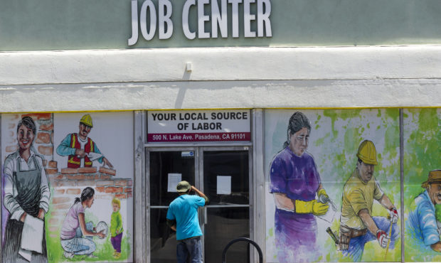 FILE - In this May 7, 2020, file photo, a person looks inside the closed doors of the Pasadena Comm...