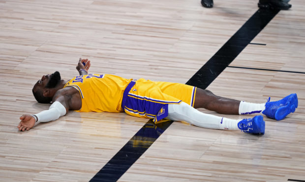 Los Angeles Lakers forward LeBron James (23) lies on the court after committing a foul during the s...