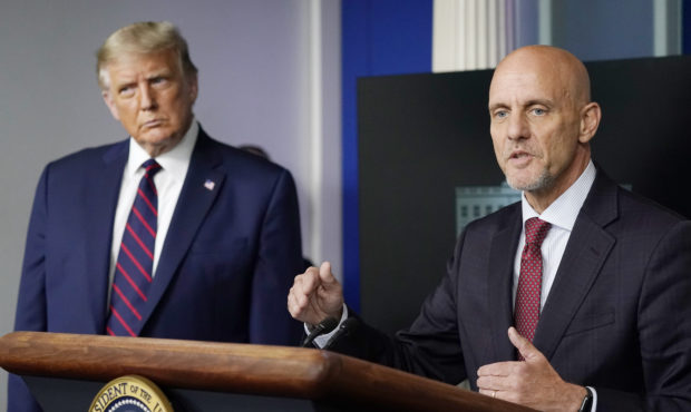 President Donald Trump listens as Dr. Stephen Hahn, commissioner of the U.S. Food and Drug Administ...