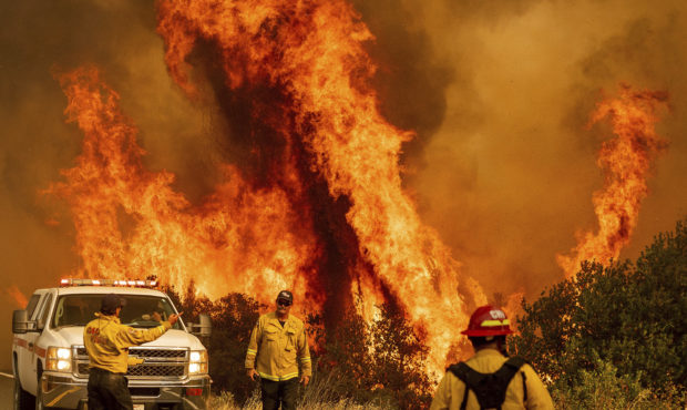 Flames from the LNU Lightning Complex fires leap above Butts Canyon Road on Sunday, Aug. 23, 2020, ...