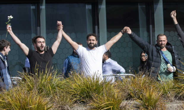 Mosque shooting survivors from left, Mustafa Boztas, Wassail Daragmih and Temel Atacocugu celebrate...