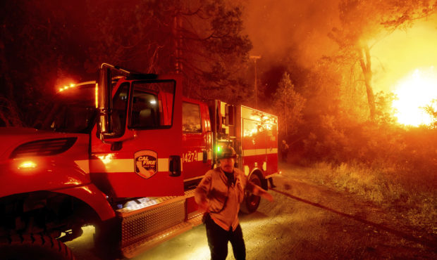 CORRECTS COUNTY TO MADERA COUNTY INSTEAD OF MARIPOSA COUNTY - A firefighter battles the Creek Fire ...