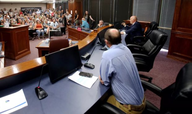 (Utah County Commission members speaking to people opposing a mandate on masks in schools.  Credit:...
