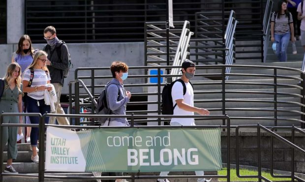 (Students walking around Utah Valley University in Orem, some with masks, many others without.  Cre...