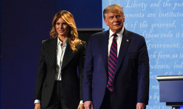 President Donald Trump stands on stage with first lady Melania Trump after the first presidential d...