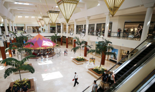 COSTA MESA, CALIFORNIA - AUGUST 31: Shoppers take an escalator in South Coast Plaza on the day it r...