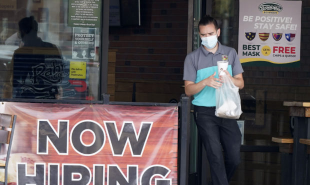 FILE - In this Sept. 2, 2020 file photo, a customer wears a face mask as they carry their order pas...