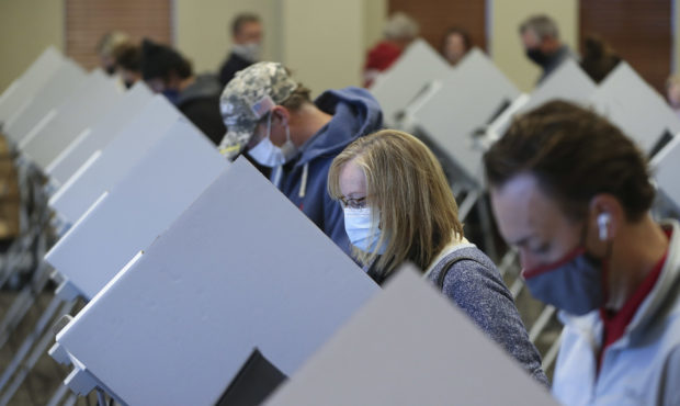 Jeanna Henderson, second from right, votes at Draper City Hall in Draper on Tuesday, Nov. 3, 2020.
...