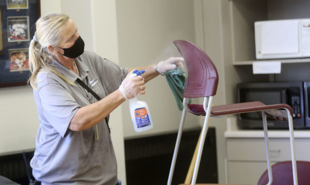 Stephanie Harrill, Skyline High School custodian, cleans chairs to get ready for the start of schoo...