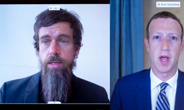 Twitter CEO Jack Dorsey (left) and Facebook CEO Mark Zuckerburg (right) speak remotely to the Senat...
