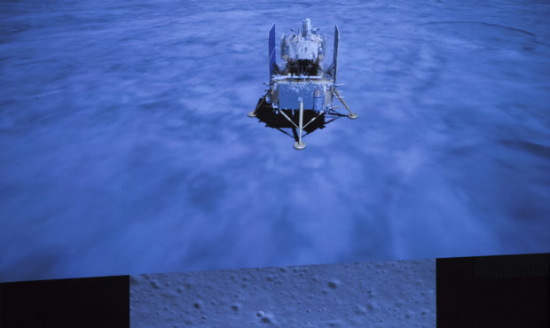 In this photo released by Xinhua News Agency, a screen shows the landed Chang'e-5 spacecraft and a ...
